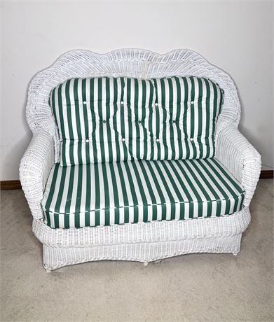 White Wicker Settee With Green and White Striped Cushion